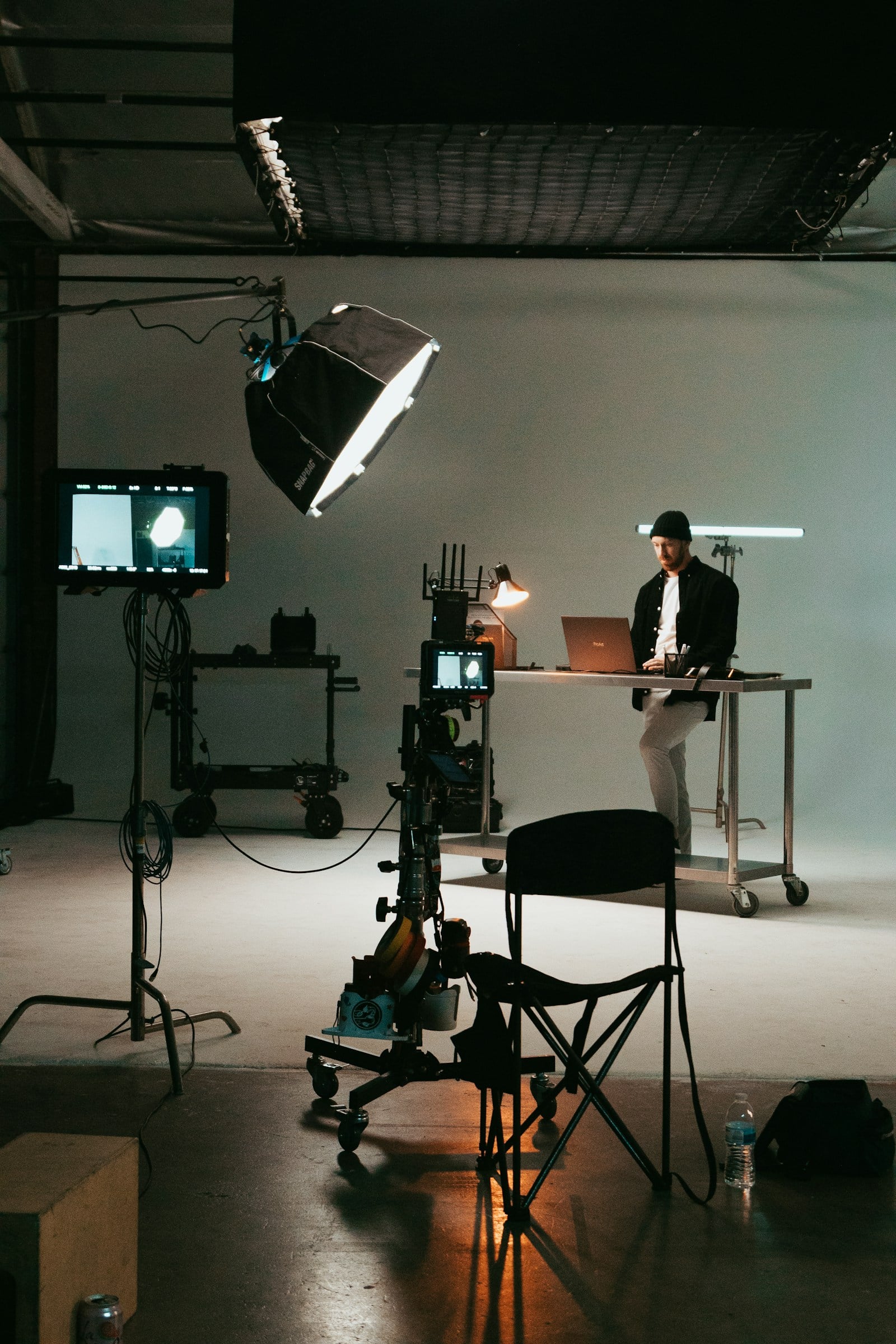 A professional production studio with a camera, lighting, and monitoring equipment